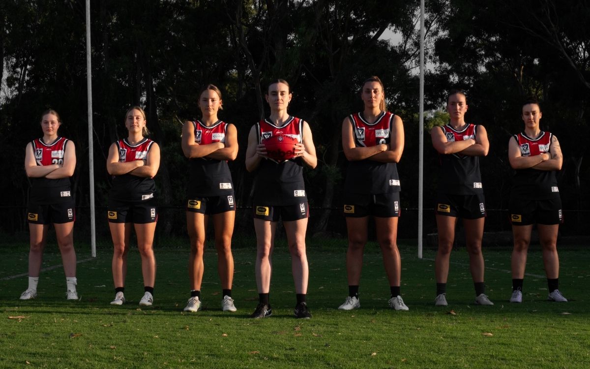 Darebin Falcons 2026 VFLW leadership group standing on the oval in Falcons guernsey